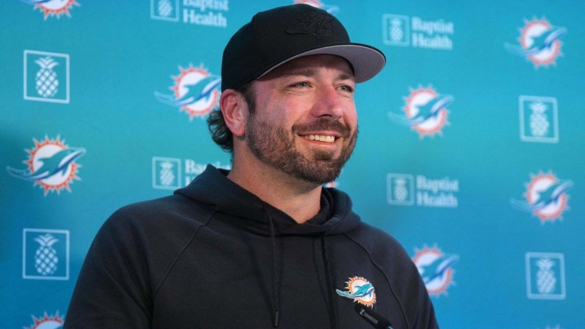 Frank Smith smiling while on a press conference.