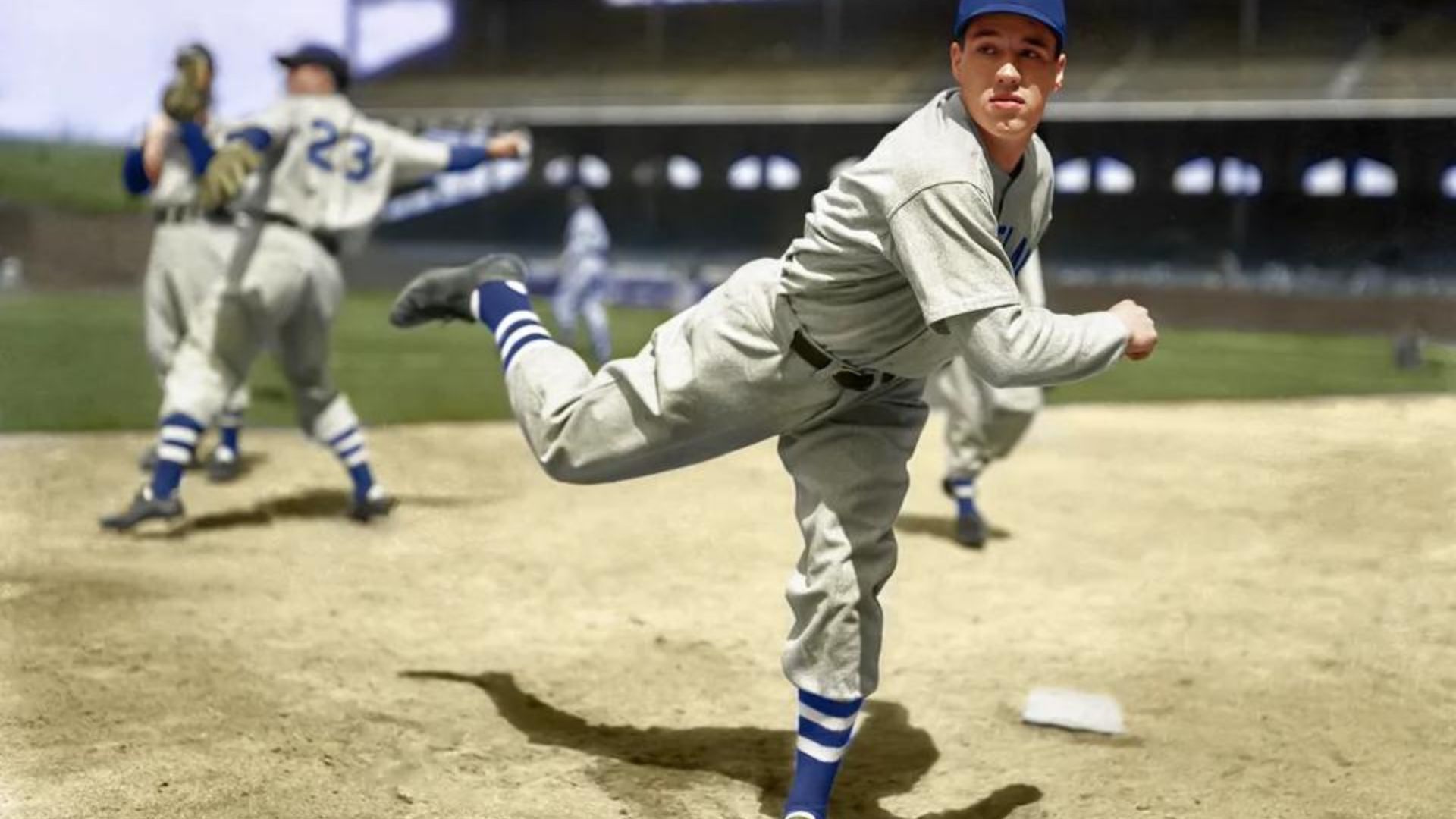Bob Feller throwing a baseball abll on the field.