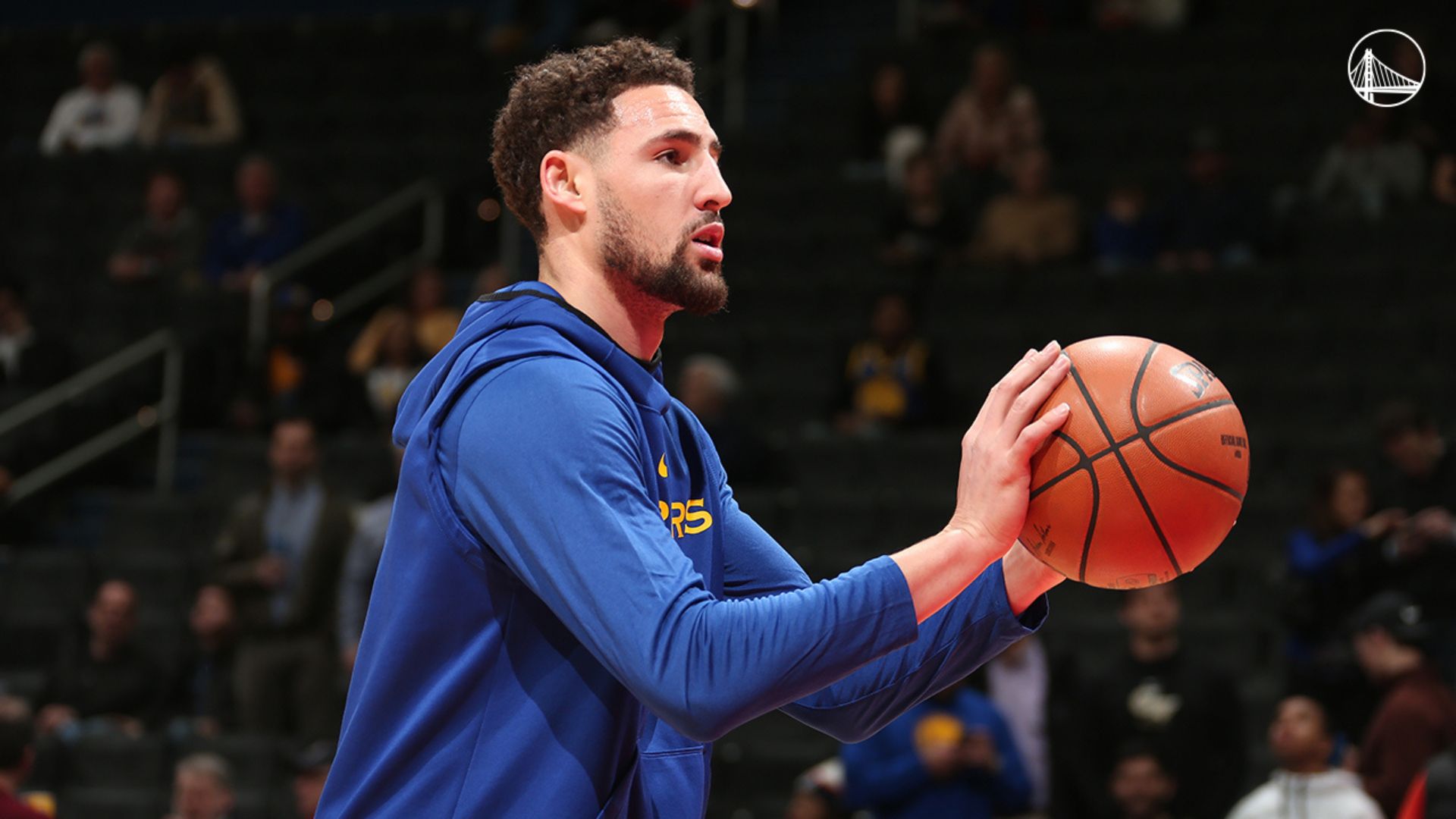 Klay Thompson holding a ball on pre game.