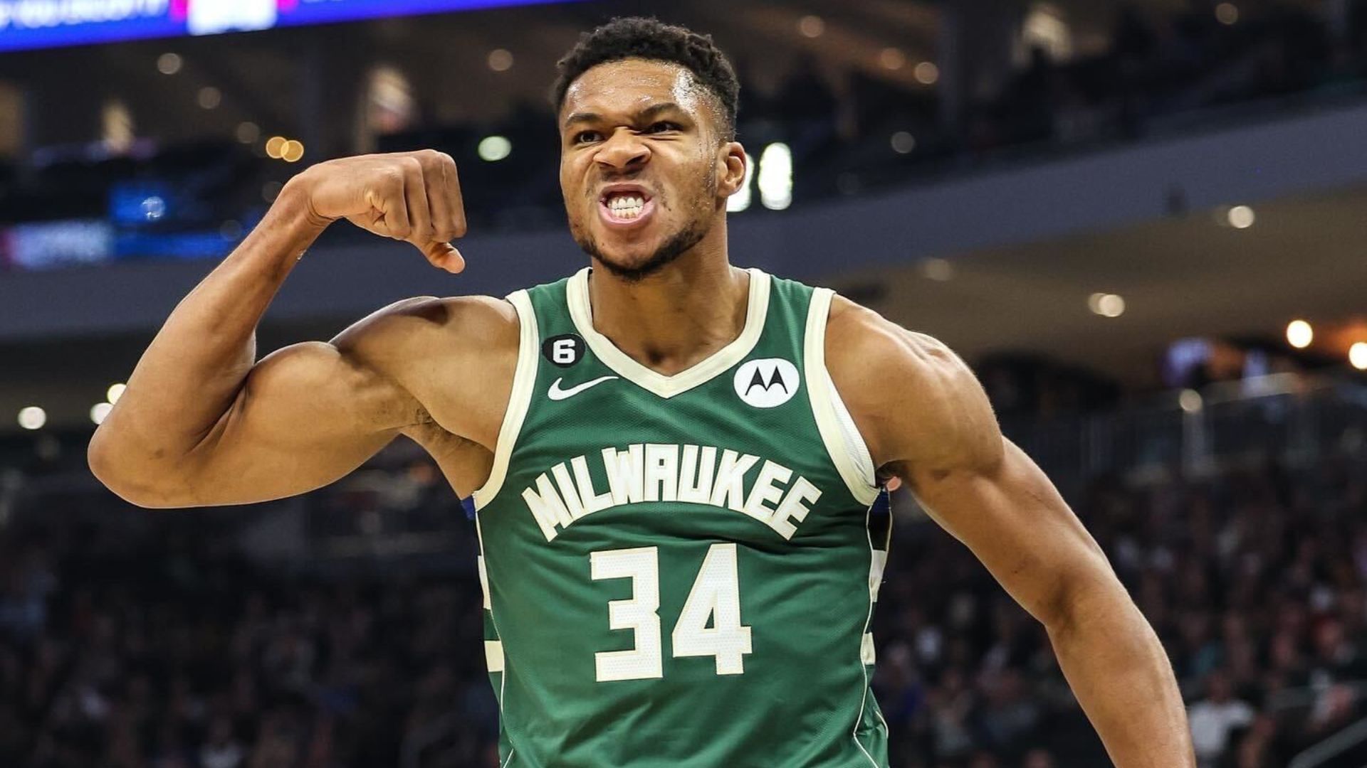 Giannis Antetokounmpo showing his biceps.