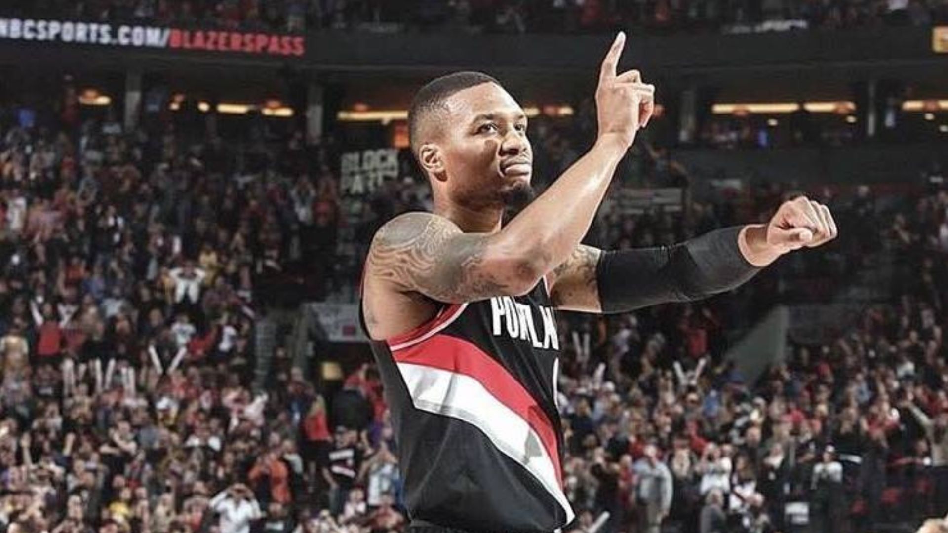 Damian Lillard making a sign to the crowd.