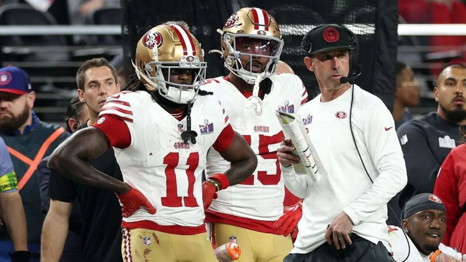 Two players waiting standing with their coach