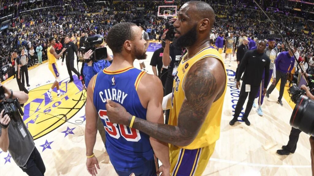 The crowd watching two legendary basketball players.